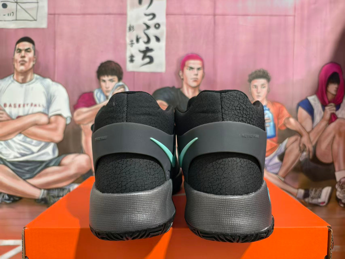 Rear view of gray and black KD-branded basketball shoes with mint accents