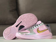 Pair of shoes showing the patterned pink outsoles and side details.