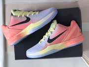 Two sneakers displayed on a black shoebox, showing the pink-and-pale-blue color scheme and translucent blue outsoles.