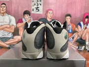 Rear view of gray, black, and white Jordan basketball sneakers showing the heel details.