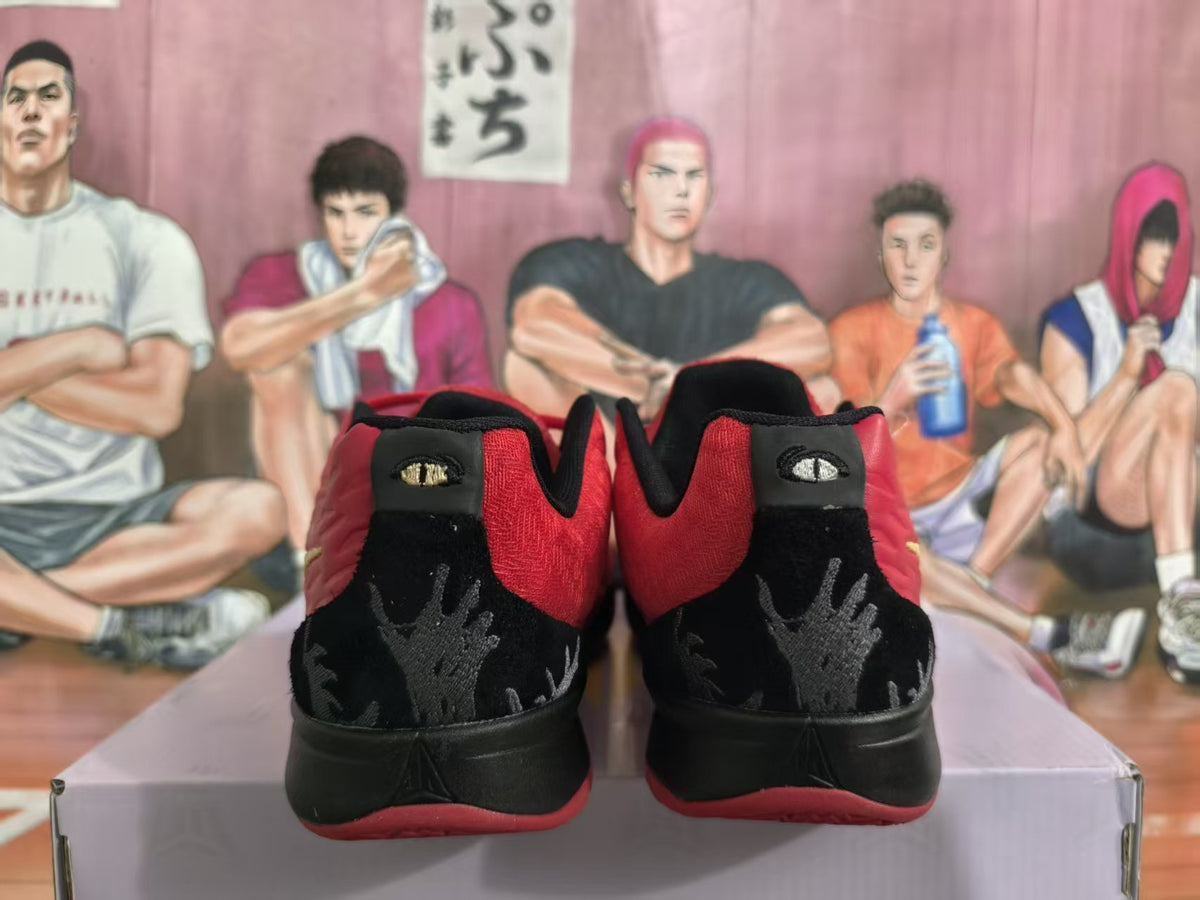 Rear view of red and black Nike basketball sneakers showing patterned black heel panels and red outsoles.