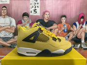 Side profile of a yellow high-top sneaker with black mesh panels, yellow laces, a white midsole, and black outsole details.