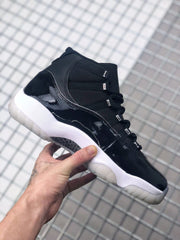 Side view highlighting the glossy black panel, black mesh upper, silver-toned eyelets, and white midsole.