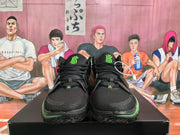 Front view of black Nike basketball sneakers with volt green accents, KD tongue branding, and black laces.