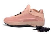 Profile view of a rust pink Jordan 40 shoe showing its low-cut upper and contrasting sole.