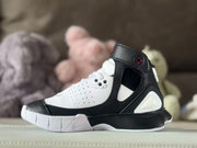 Rear-side view showing the black heel section, white insert, and ankle strap.