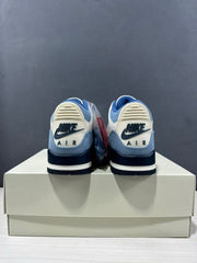 Rear view showing the Nike Air heel branding, blue heel panels, and dark navy midsoles.