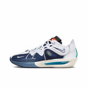 Side view of a white and navy Nike GT Cut 3 sneaker with orange tongue detailing and a blue outsole.