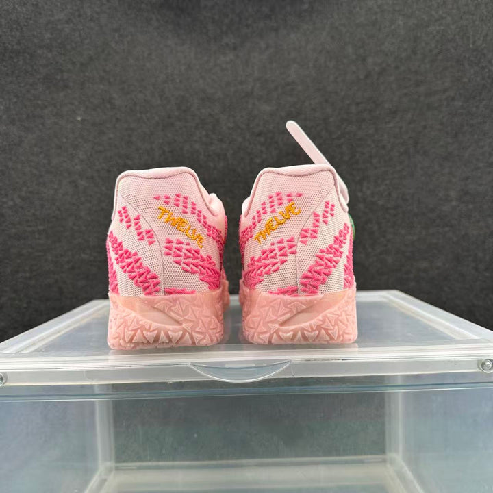 Rear view of pink and white Nike basketball sneakers with textured uppers and pink patterned soles.