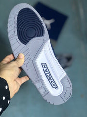 Outsole view with grey tread and a dark navy circular traction section.
