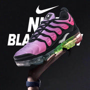 Pink and black Nike TN-21 sneaker shown against a dark graphic background