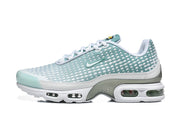 Side view of a teal and white Nike Air Max Plus VII sneaker.