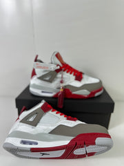 Pair of white and gray Jordan Dub Zero sneakers with red accents displayed on a black shoebox.