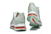 Rear and outsole views of Nike Pegasus Premium shoes with mint tread and red-tinted sole details.