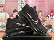 Two black Nike basketball shoes arranged at an angle, showing their low-cut shape and contrasting Swoosh accents.