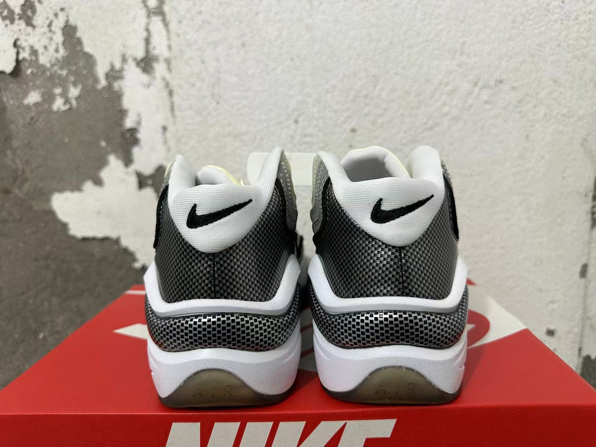 Rear view of grey, white and black Nike sneakers with patterned heel panels
