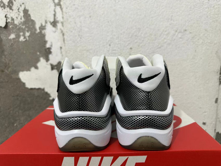 Rear view of grey, white and black Nike sneakers with patterned heel panels