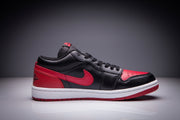Single black and red low-top sneaker shown in side profile with a white midsole.