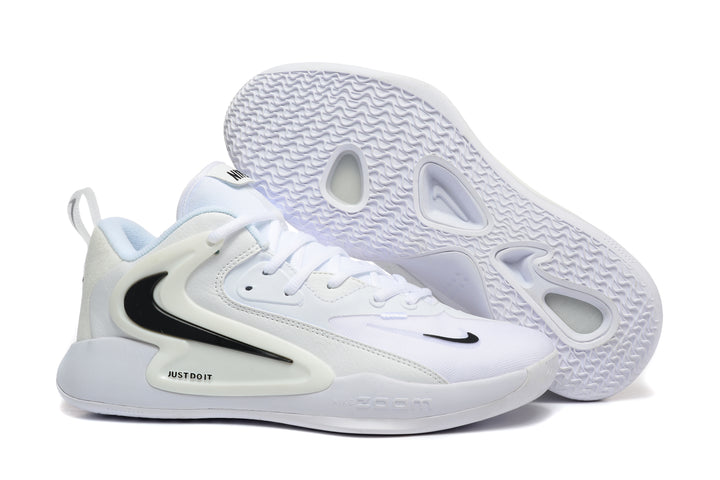 White Nike 911-style lace-up sneaker with black Swoosh details, shown beside its patterned outsole.