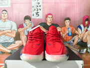 Front view of red Nike basketball shoes with red laces and white midsoles.