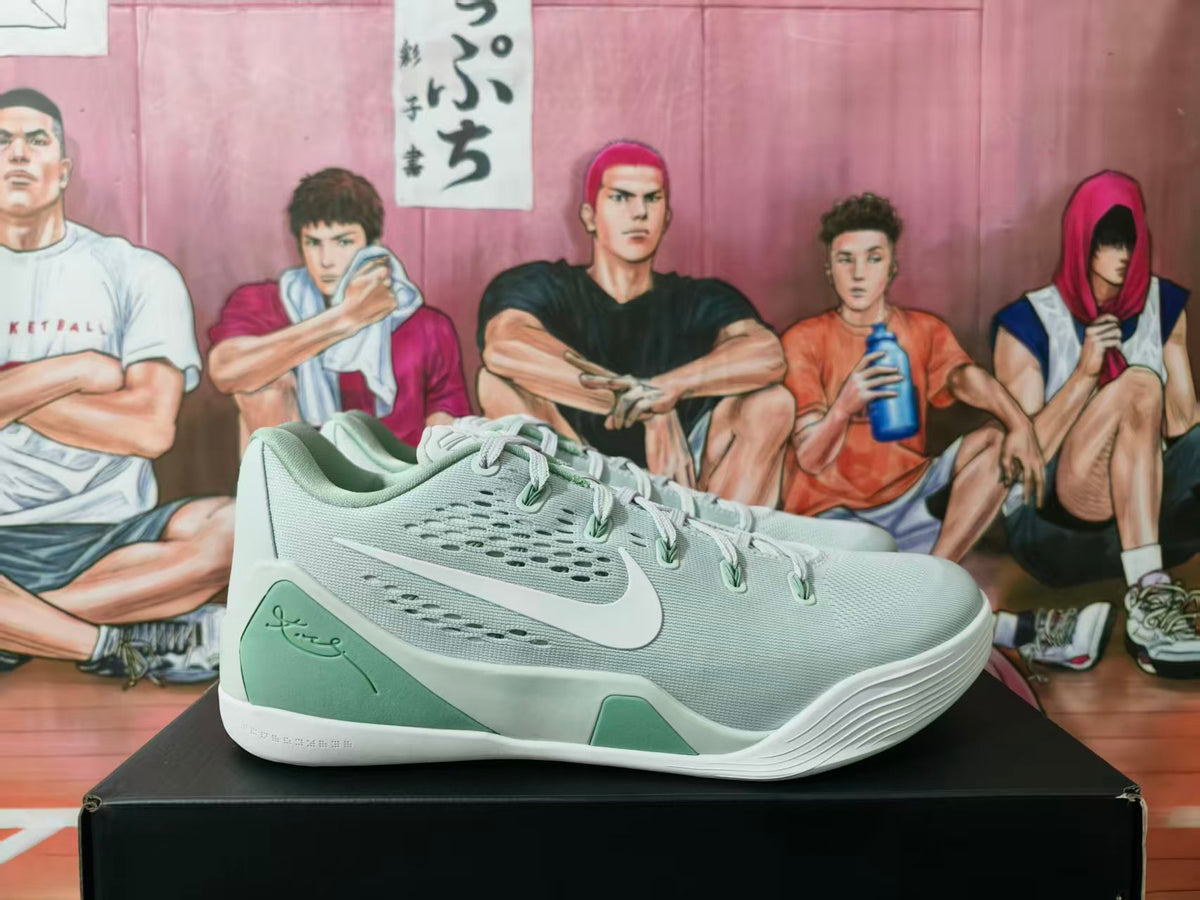 Side view of green and white Nike basketball sneakers displayed on a black box.