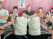 Rear view of white Nike basketball shoes showing textured heels and pale green heel lettering.