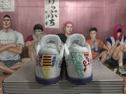 Rear view of the shoes, showing multicolor graphics and dark blue outsoles.