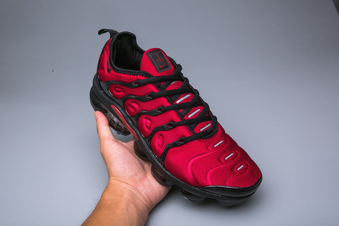 Red and black Nike TN sneaker shown from above at an angle.