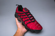 Red and black Nike TN sneaker shown from above at an angle.