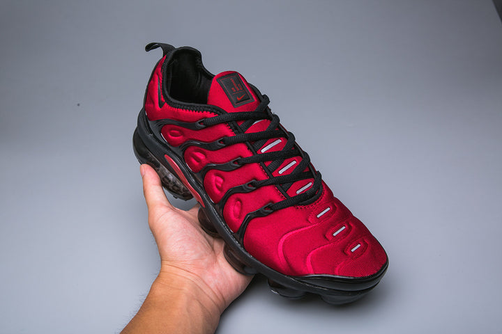 Red and black Nike TN sneaker shown from above at an angle.