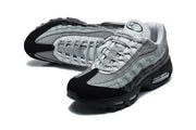 Pair of grey and black Nike Air Max 95 sneakers in a three-quarter view