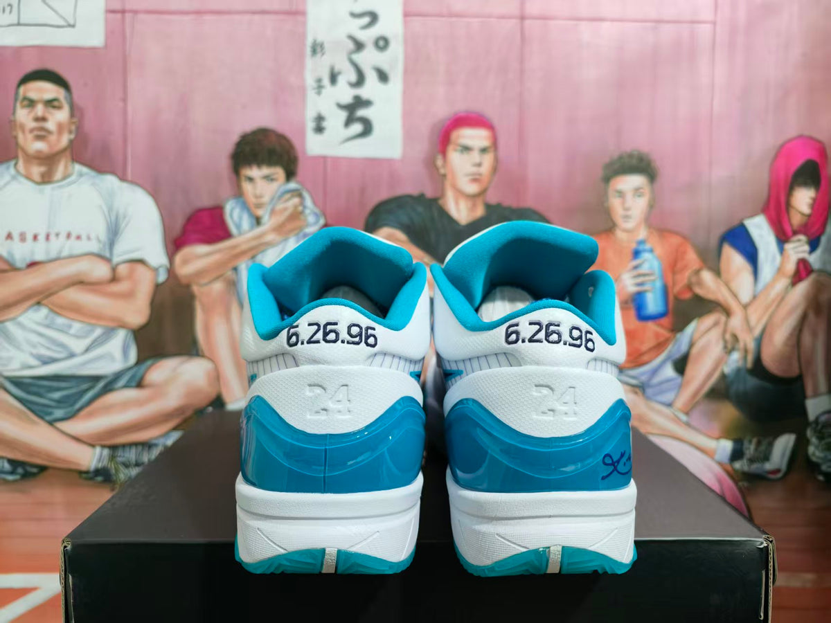 Rear view of white and teal Nike Kobe basketball shoes with 6.26.96 heel detailing.