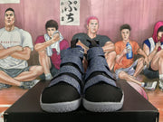 Front view of black and purple high-top basketball shoes with layered strap closures and light-colored textured soles.