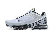 Side view of a white and black Nike sneaker with visible cushioning units.
