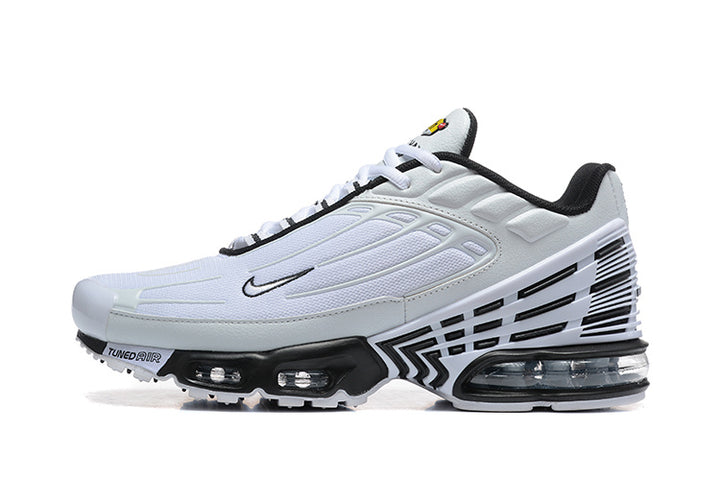 Side view of a white and black Nike sneaker with visible cushioning units.