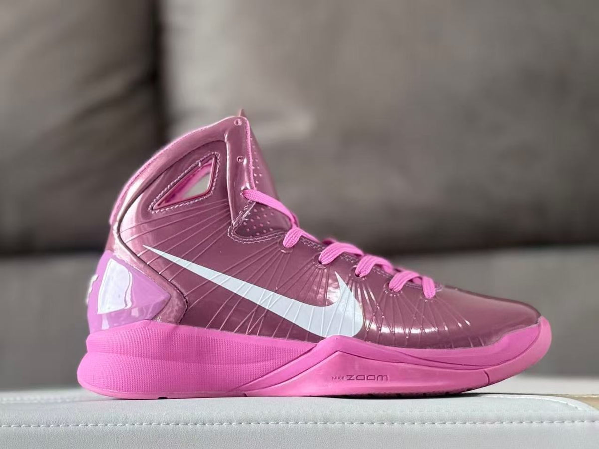 Side view of a mauve and pink Nike high-top basketball shoe with a white Swoosh.