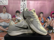 Angled display of the pair highlighting the side Swoosh, mesh-style panels, cream laces, and pale yellow toe areas.