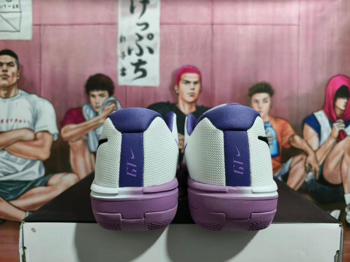 Rear view of white and purple Nike basketball shoes showing heel details and purple outsoles