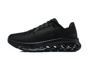 Side profile of a black On running shoe showing its upper and cutout outsole.