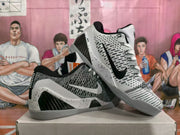 Angled view of the paired sneakers displaying the patterned uppers, contrasting Swooshes, and speckled midsoles.