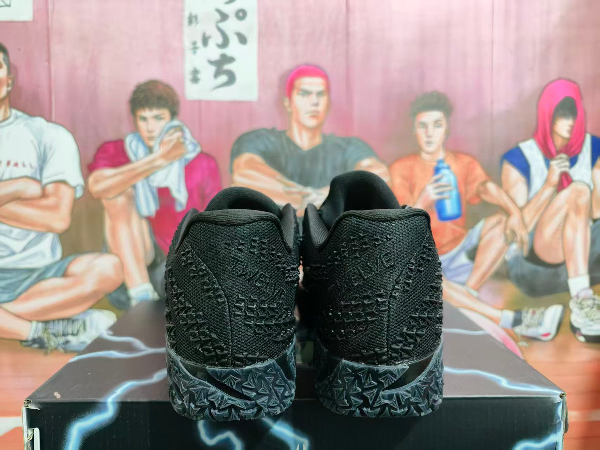 Rear view of black textured Nike sneakers with patterned outsoles