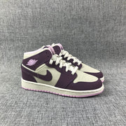 Three-quarter front view of the pair with white panels, purple overlays, and pink outsoles.