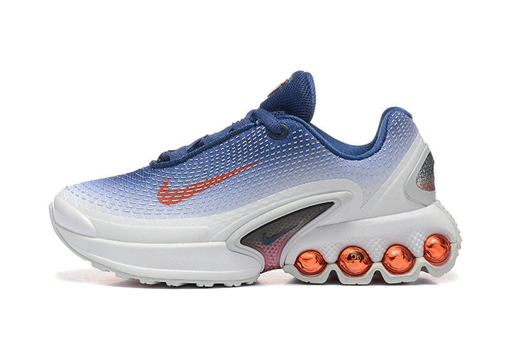 Side view of a blue and white Nike low-top sneaker with a red side logo and orange circular heel accents.