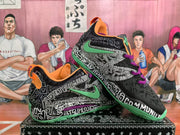 Angled display of the pair highlighting the graphic print, green side branding, purple laces, and orange collar lining.