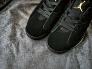 Close-up of the black toe boxes, laces, and perforated upper panels on the Jordan Air Jordan 6 sneakers.