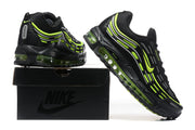 Black Nike Air Max sneakers with volt accents displayed on a black shoebox