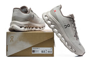 Gray On Cloudmonster 3 shoes beside a box label showing EU 42.5, US M 8.5 and US W 10