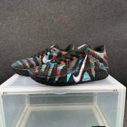 Three-quarter view of black and multicolor sneakers showing the side Swoosh and ZoomX marking.