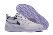 Purple Nike sneaker shown with the patterned outsole facing upward.