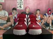 Front view of red and white Nike Air More Uptempo sneakers with lace-up closure